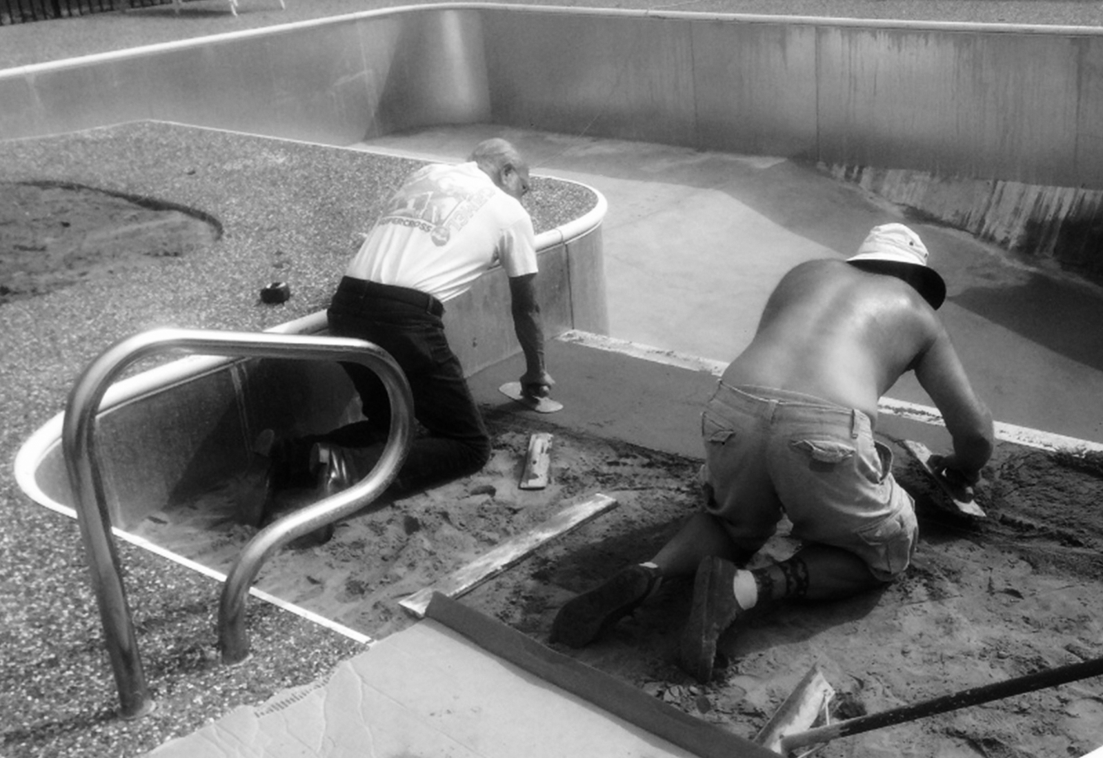 Steve Bennett II and his father working on a pool together.